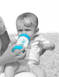 Feed baby in upright position to prevent acid reflux