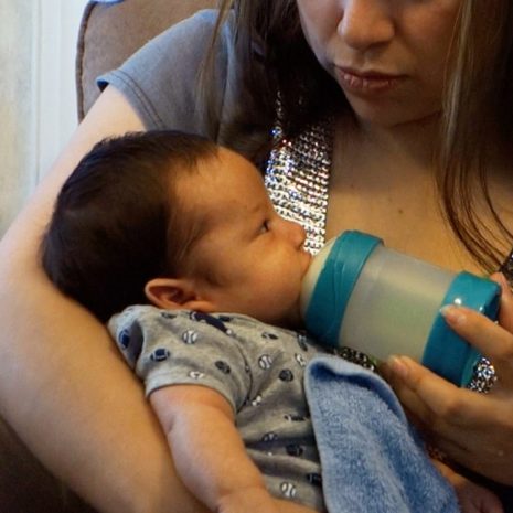 Gassy baby feeds in upright position